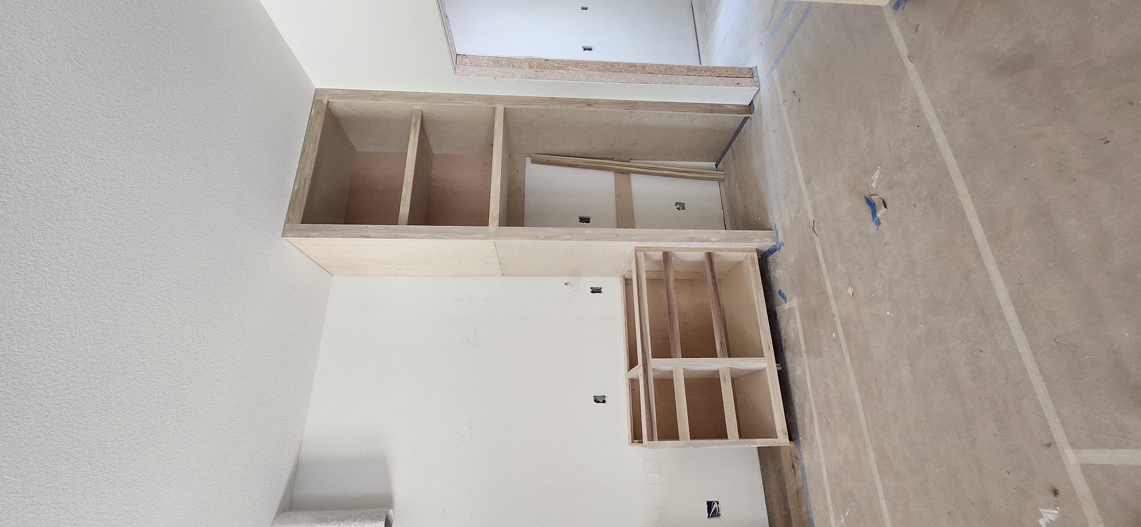 Custom built-in shelving unit being installed in living room