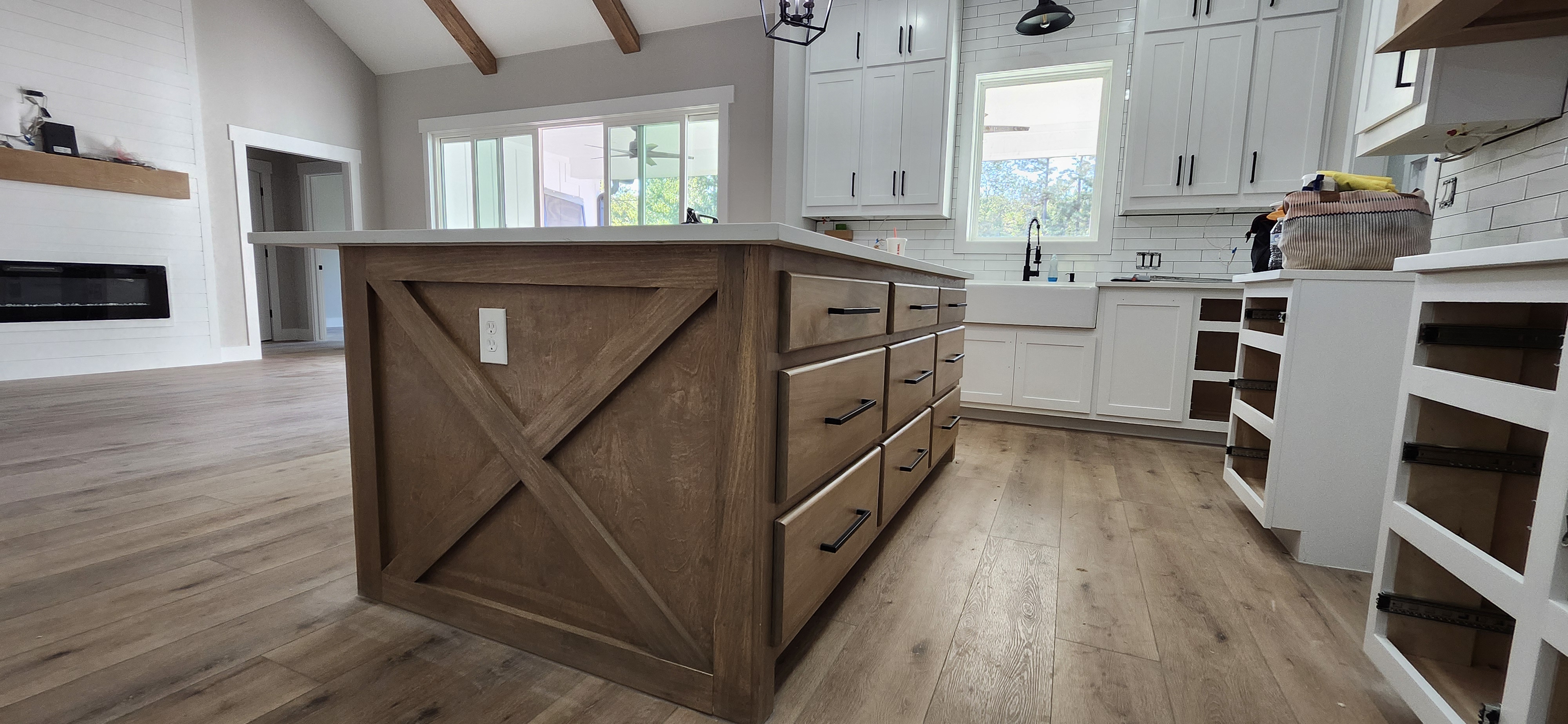 Custom kitchen island with barn door X panel detail and quartz countertop