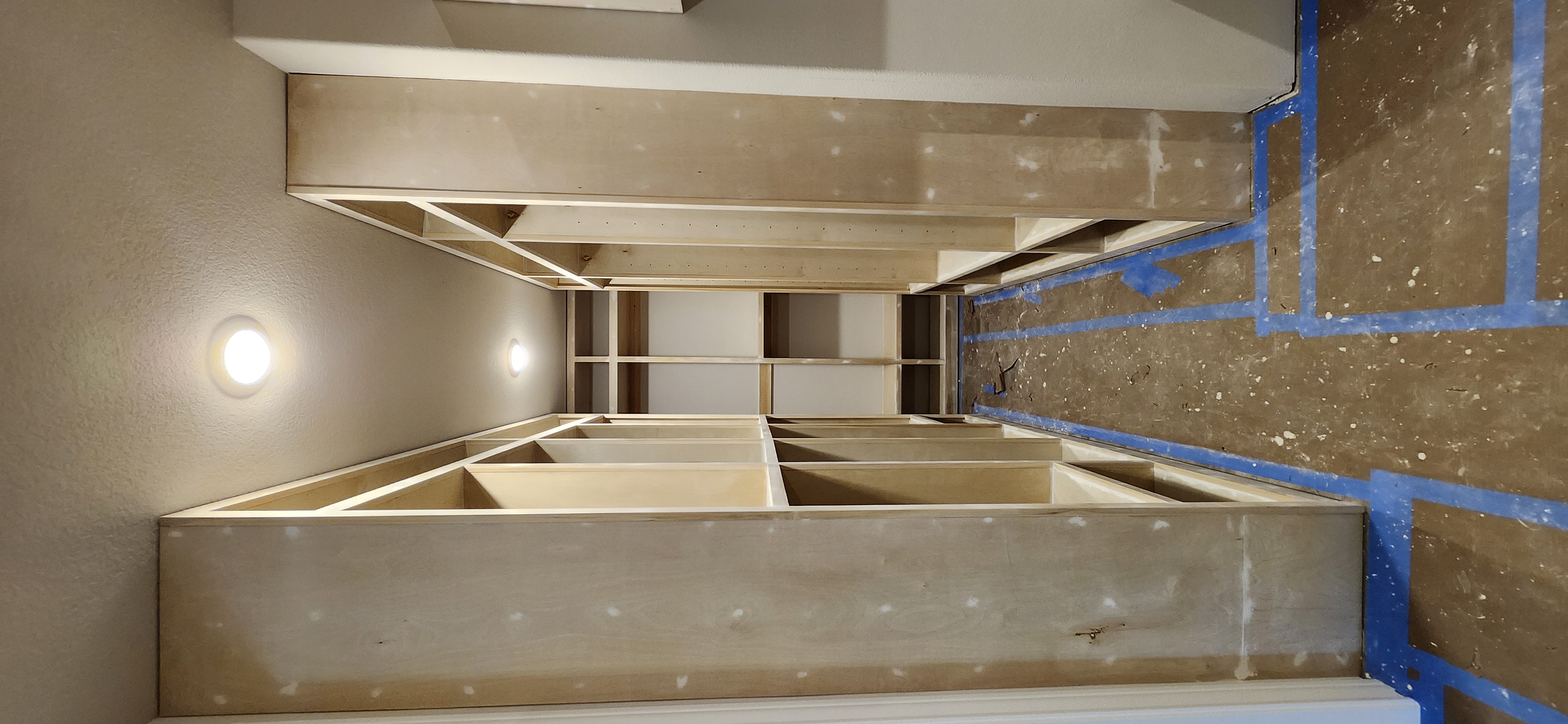 Closet hallway both sides shelving units during installation