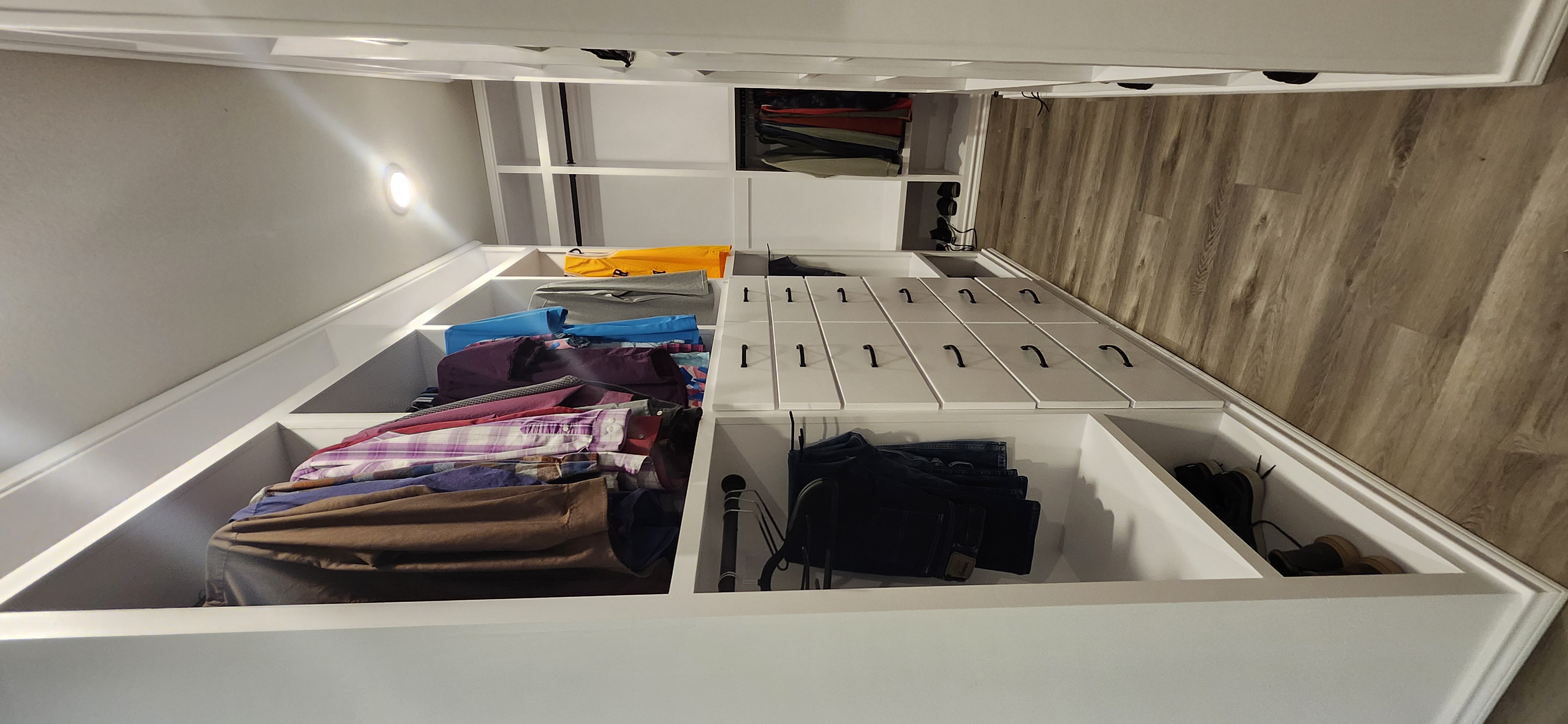 Men's custom closet hanging shirts drawer tower full aisle view