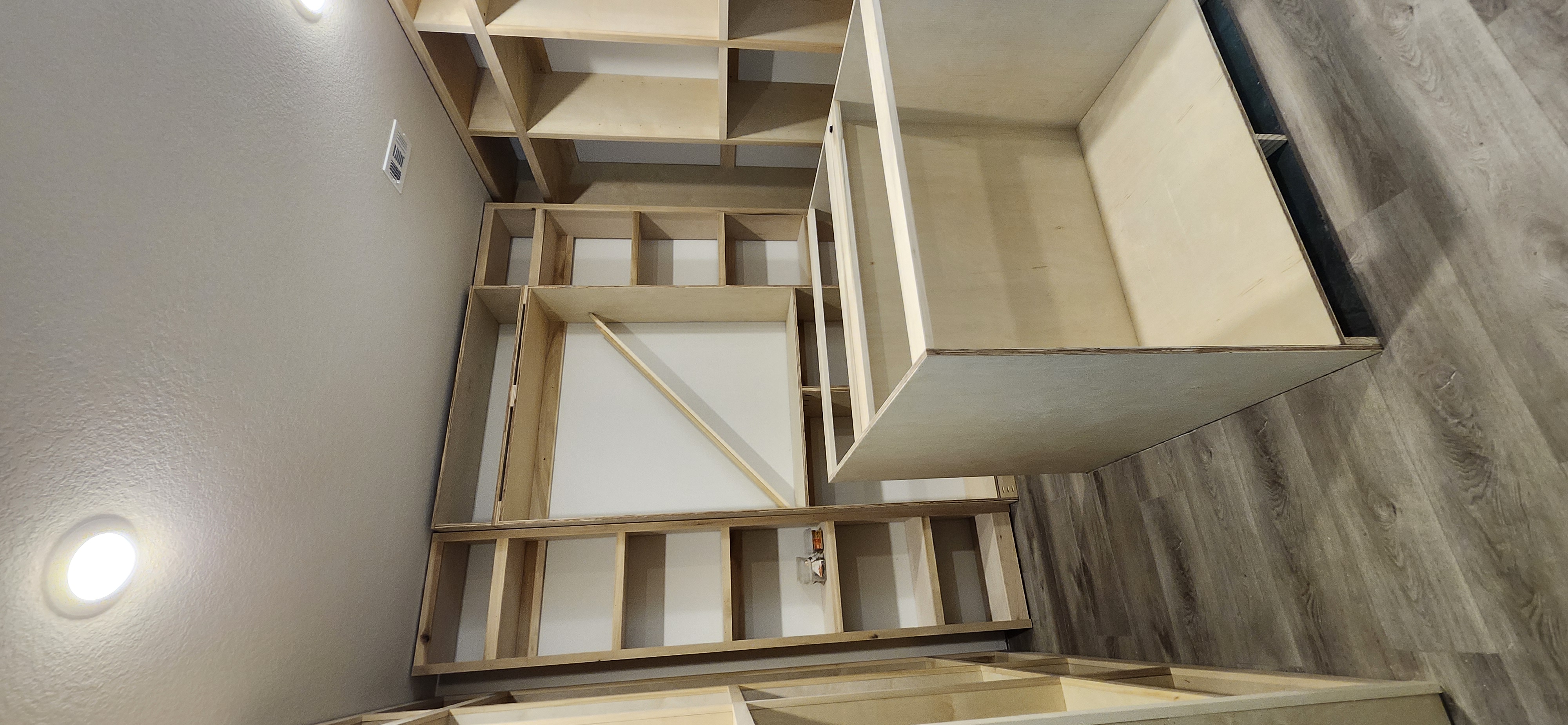 Walk-in closet raw build with center island and full surround shelving