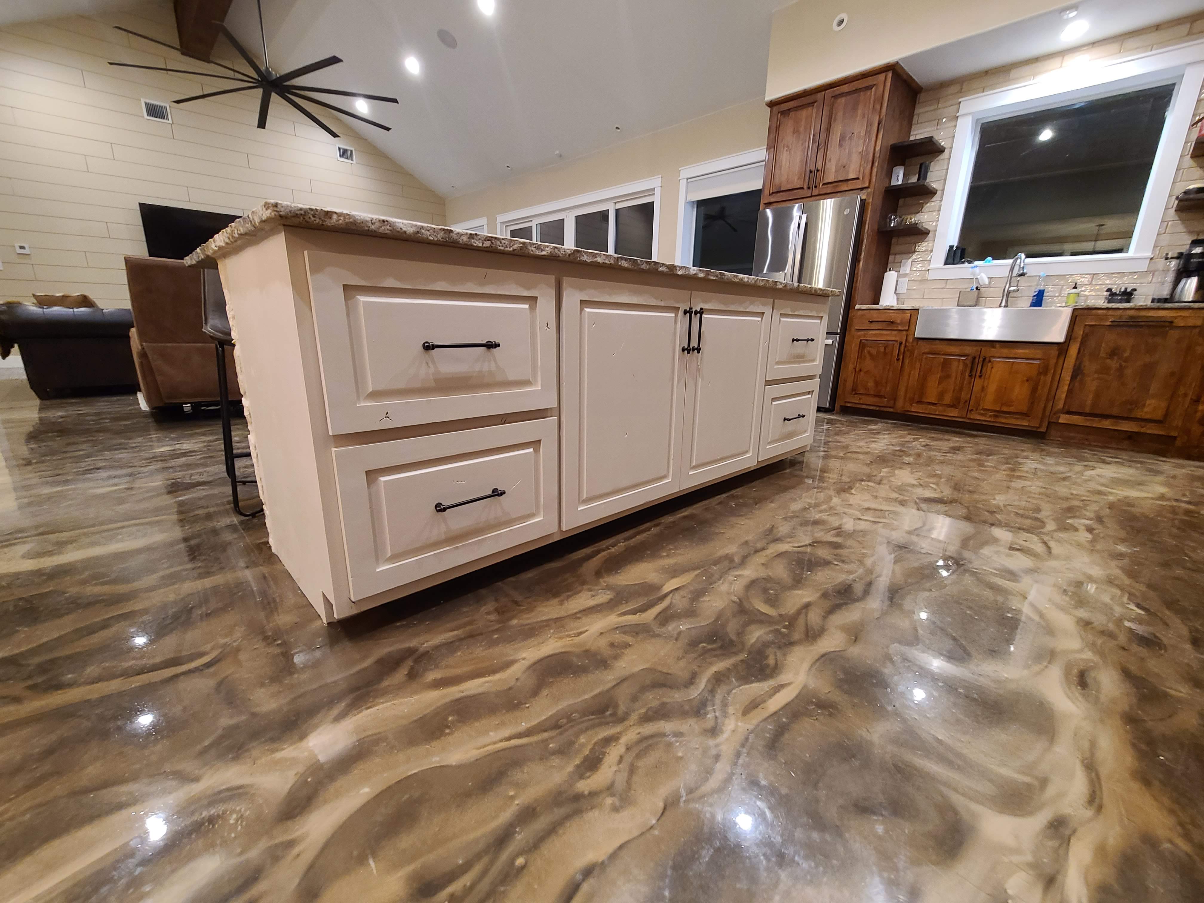 Custom epoxy concrete floor swirl finish kitchen island open concept ranch home