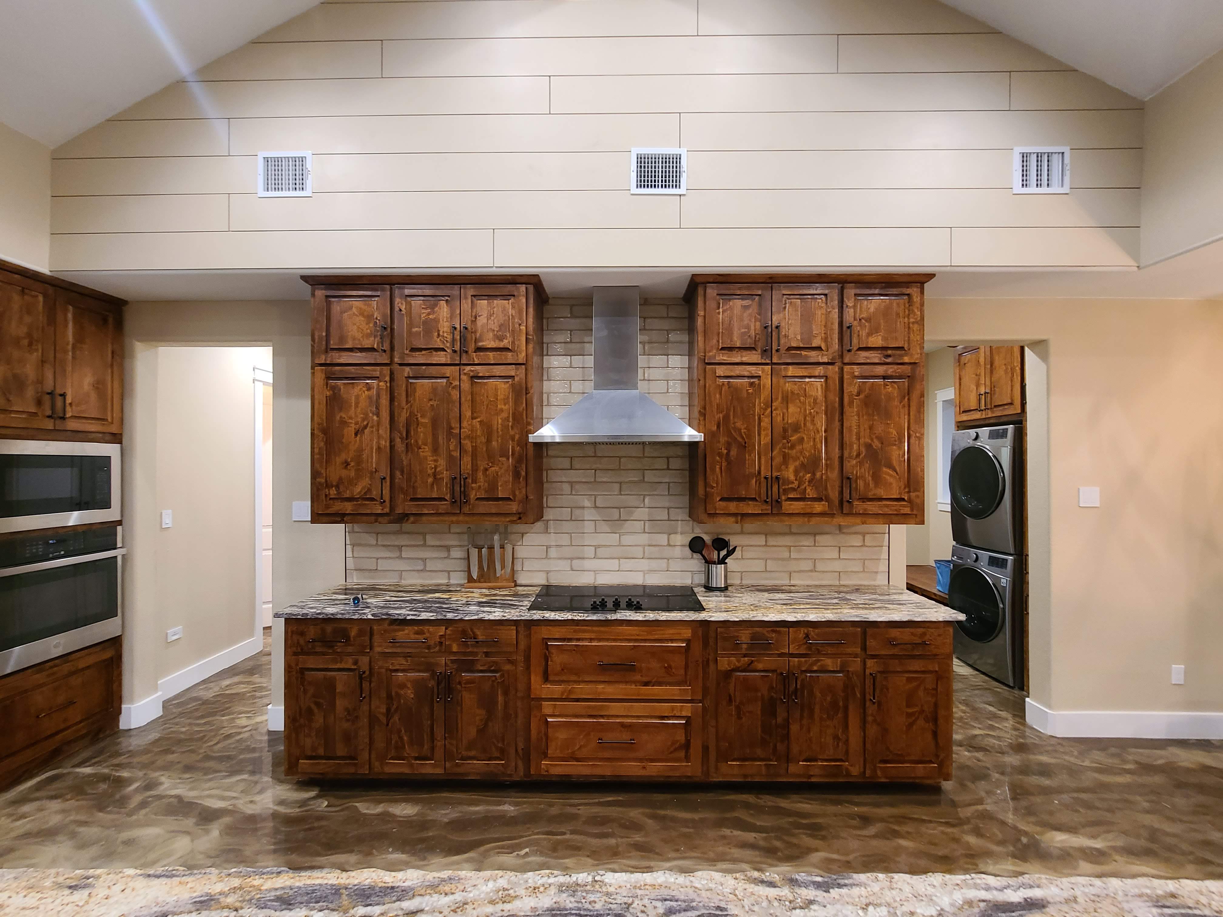 Custom kitchen range wall knotty alder cabinets vaulted shiplap ceiling