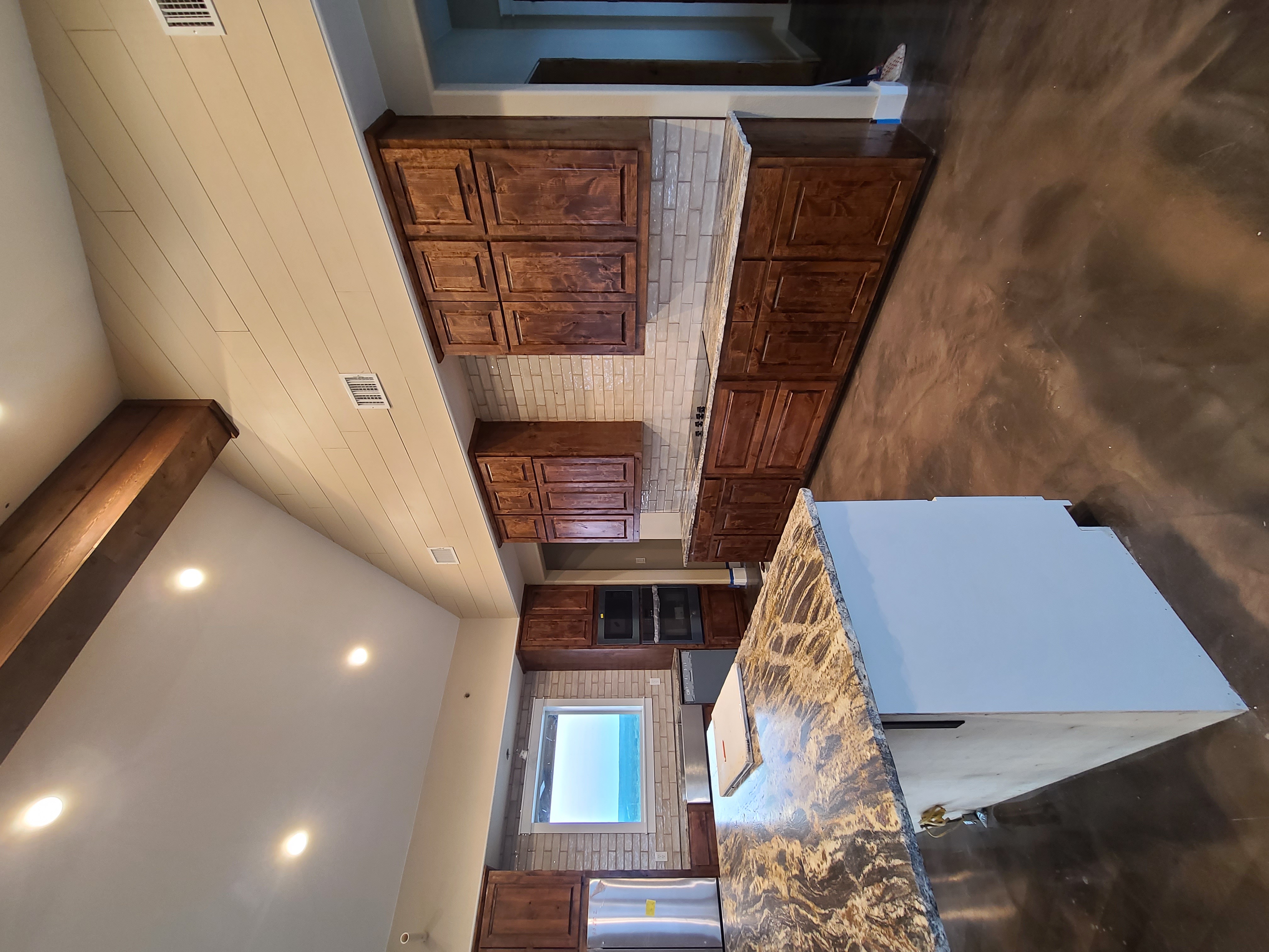 Custom kitchen vaulted ceiling exposed beam granite island knotty alder cabinets