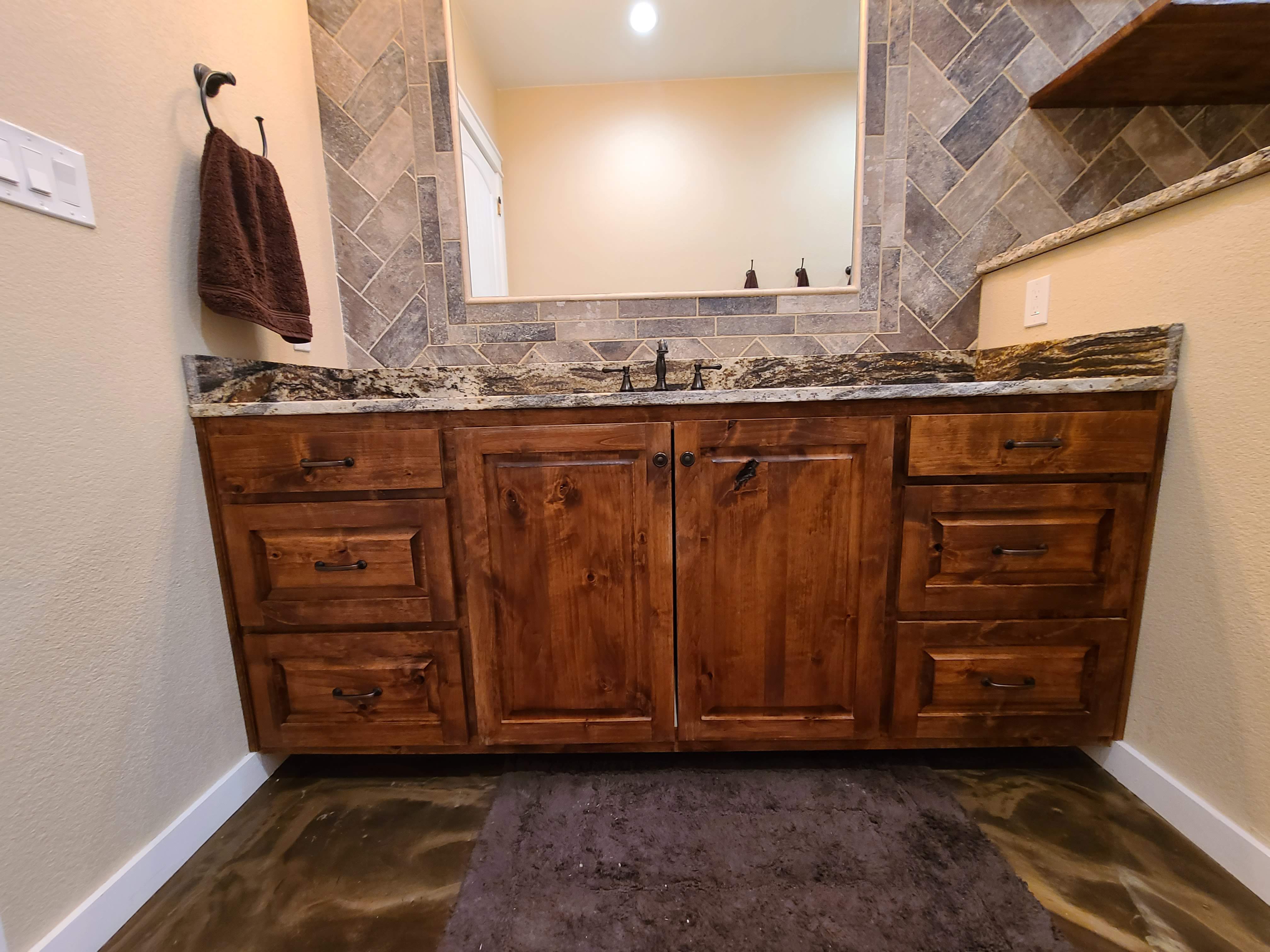 Master bath custom knotty alder vanity live edge granite countertop diamond tile