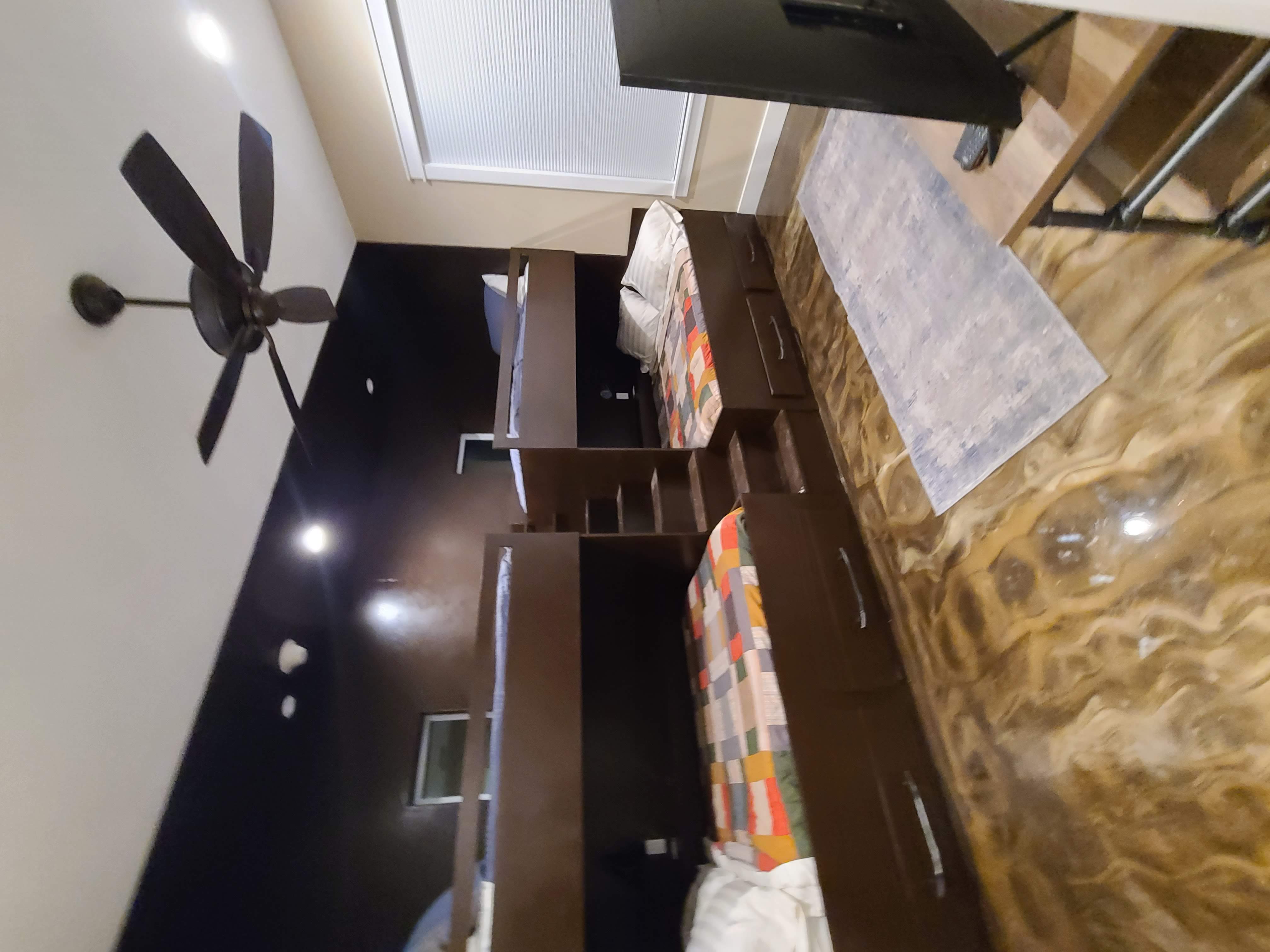Custom bunk room built-in dark wood bunk beds epoxy floor