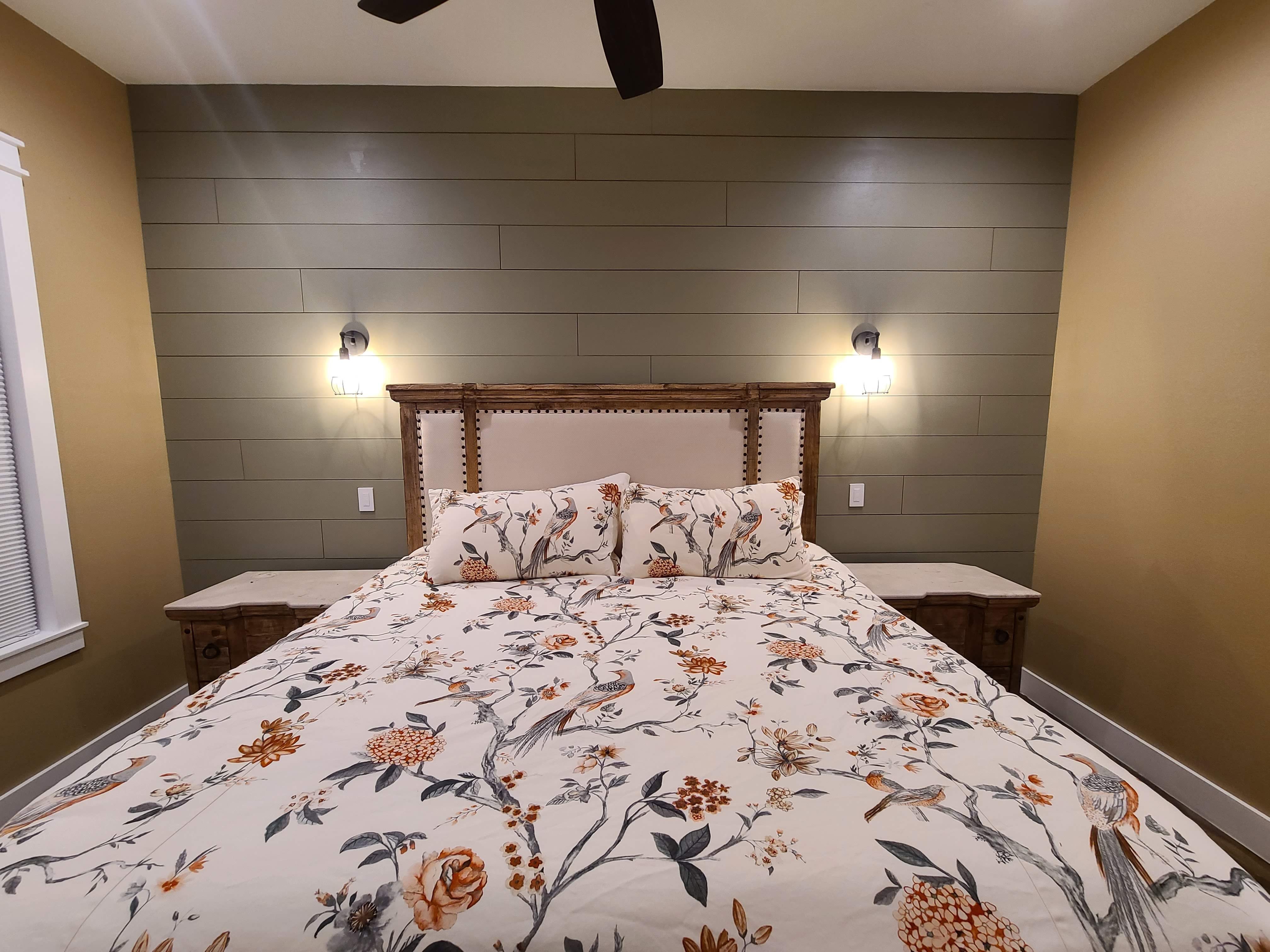 Guest bedroom sage green shiplap accent wall sconce lighting